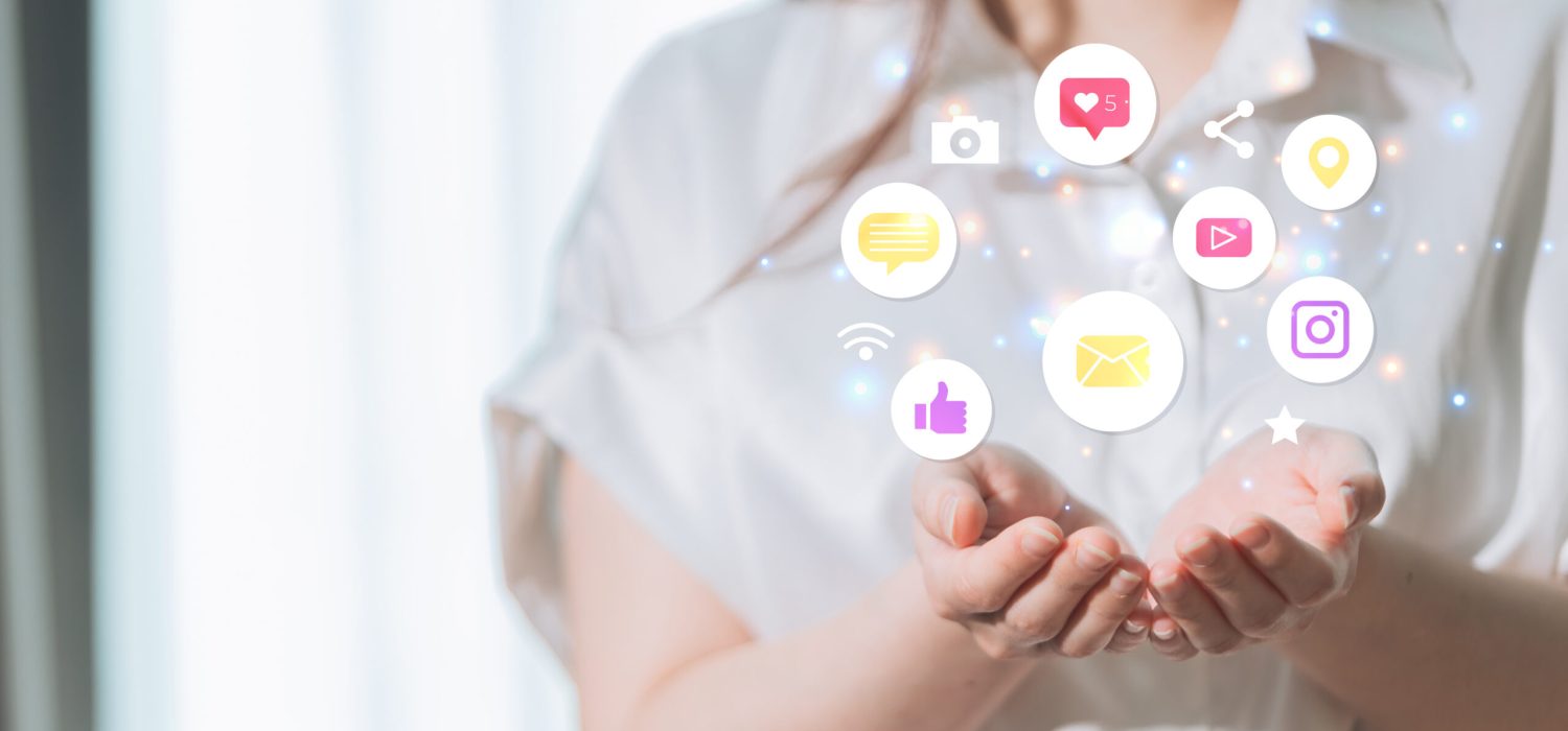Woman holding social media icons in her hands. Communication and networking concept