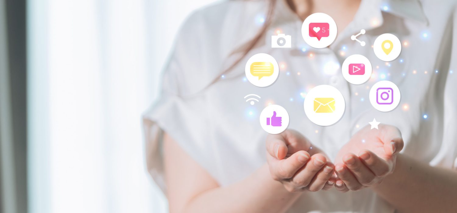 Woman holding social media icons in her hands. Communication and networking concept